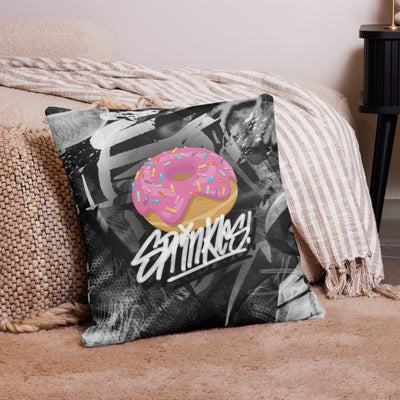 22 x 22 inch premium pillow covered in layered black and white graffiti abstract on both sides. There is a pink donut with sprinkles on the front, tagged over with the name 'Sprinkles' in white graffiti.